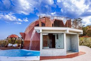 a house with a swimming pool and a dome at Cipó Cabanas in Santana do Riacho
