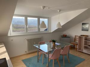 a kitchen and dining room with a glass table and chairs at Oberdorf in Konstanz