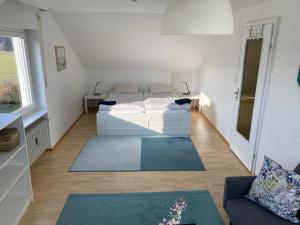 a living room with a white couch and a window at Oberdorf in Konstanz