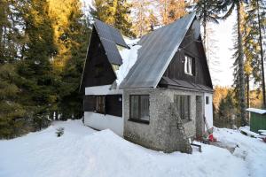 a house with snow on the side of it at Andrea Chata in Štrba
