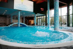 a large pool of water in a building at SPA Hotel Olymp in Velingrad