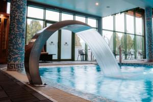 a swimming pool with a water slide in a building at SPA Hotel Olymp in Velingrad