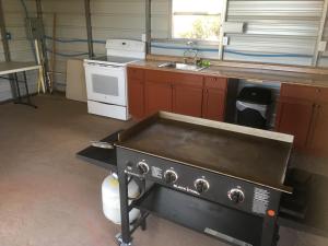 a kitchen with a stove and a sink at Bluebell Cabin, Glamour Cabin Camping, Stunning Night Sky in Monticello