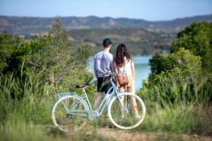 a man and a woman standing next to a bike at Camping Taiga Lake Caspe - Maeva Vacansoleil in Caspe