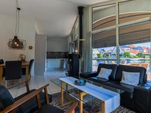 a living room with a couch and a table at Aquaronde 110 in Lemmer