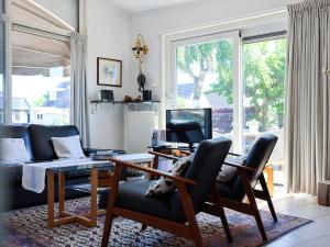 a living room with a table and chairs and a couch at Aquaronde 110 in Lemmer