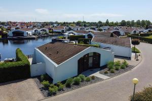 arial view of a house next to a river at Aquaronde 093 in Lemmer
