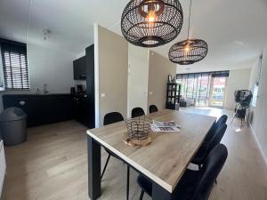a dining table and chairs in a living room at Park De Marol Grutto 8 in Lemmer