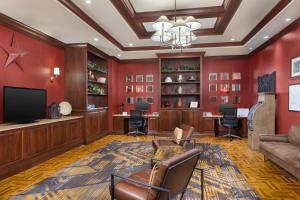 a living room with red walls and a flat screen tv at DoubleTree by Hilton Cincinnati Airport in Hebron