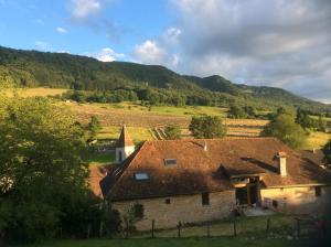 a house in the middle of a field with a mountain at Le RepAire de La SalAmandre in Ivrey +14 photos