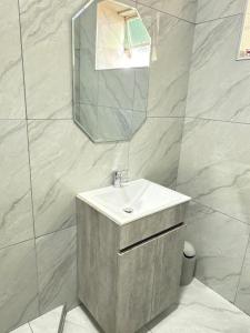 a bathroom with a sink and a mirror at Marico Bosveld Guesthouse in Zeerust +35 photos