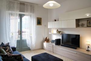 a living room with a couch and a television at Tana del Manzoni in Barzio