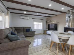 a living room with a couch and a table at Winahost Villa Unión in Puebla de Vallbona