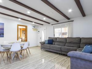 a living room with a couch and a table at Winahost Villa Unión in Puebla de Vallbona