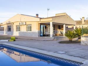 a house with a swimming pool in front of it at Winahost Villa Unión in Puebla de Vallbona