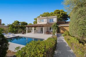 a home with a swimming pool and a house at Villa Sa Sirvi in Santa Ponsa