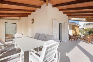 a white dining table and chairs on a patio at Villa Sa Sirvi in Santa Ponsa