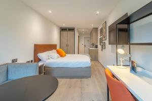 a bedroom with a bed and a desk and a table at For Students Only Space St Andrews in St. Andrews