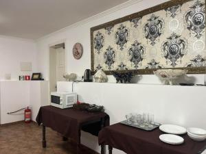 a living room with a table and a microwave at Приватна садиба Фортеця Малехів in Lviv
