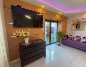 a living room with a large flat screen tv on a wall at Asenata Apartament 46m2 Ustroń Centrum in Ustroń