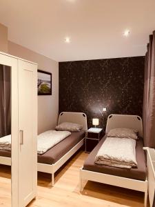 a bedroom with two beds and a wall with stars at Apartment End in Heidelberg