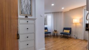 a room with a chest of drawers and a living room at Sítio do Castelo Beach in Cascais by LovelyStay in Cascais