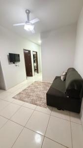 a bedroom with a bed and a ceiling fan at Canastra House in Delfinópolis