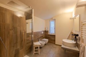 a bathroom with two toilets and a shower at Hirondelle Locanda Vegana in Aosta +57 photos