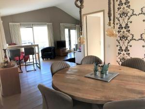 a dining room with a wooden table and chairs at Aquaronde 073 in Lemmer