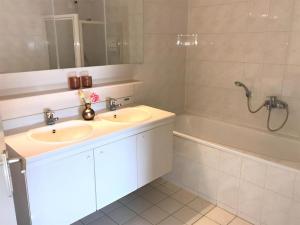a bathroom with a sink and a tub and a mirror at Aquaronde 073 in Lemmer