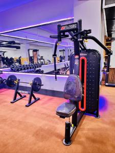 a gym with a treadmill and a chair in it at Herat Star Hotel in Herāt