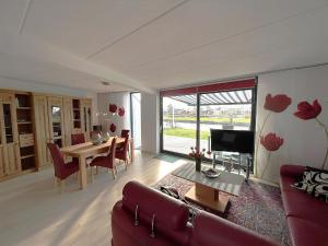 a living room with a couch and a table at Park Brekkense Wiel 037 in Lemmer
