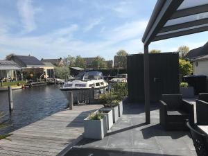 a boat is docked at a marina at Park De Markol River House in Lemmer