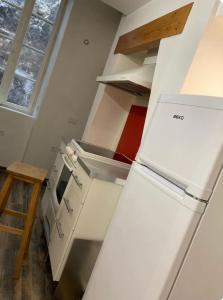 a kitchen with a white refrigerator in a room at City centre appartement en colocation in Chambéry