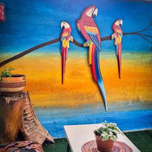 a painting of three birds on a wall at Casa la Colina in Macanal