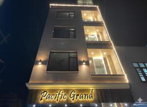 a tall building with a sign in front of it at Pacific Grand in Amritsar