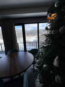 a room with a christmas tree and a table at X2 4Rest Bakuriani in Bakuriani