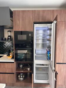 a refrigerator with its door open in a kitchen at X2 4Rest Bakuriani in Bakuriani +19 photos
