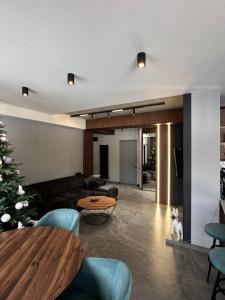 a living room with a couch and a table at X2 4Rest Bakuriani in Bakuriani