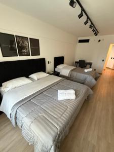 a large bedroom with two beds in it at Hotel Sol Alphaville1505 in Barueri +10 photos