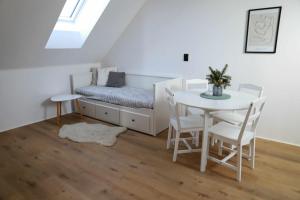 a bedroom with a bed and a table and chairs at Šťastná 118 in Sněžné