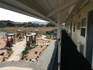 a balcony with a row of tables and potted plants at Travelodge by Wyndham Fairfield/Napa Valley in Fairfield