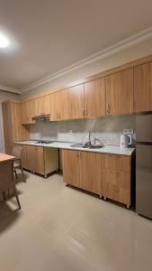 a kitchen with wooden cabinets and a sink at RAA apartments in Qusar