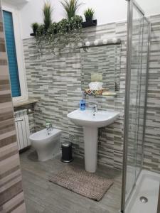 a bathroom with a sink and a toilet and a shower at La Casa delle Onde B&B in Pescara +39 photos