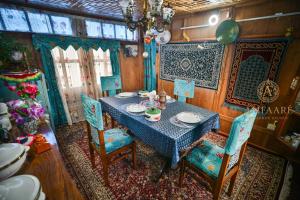 a dining room with a blue table and chairs at Dolphin houseboat in Srinagar