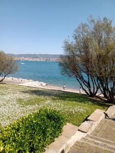 a view of a beach with people walking on the beach at Appartamento Nerio in Muggia
