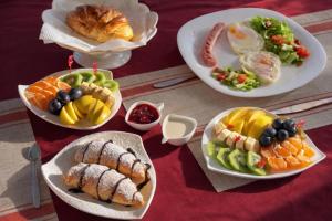 a table with plates of food on a table at Мурас Эко - Ресорт in Alamedin