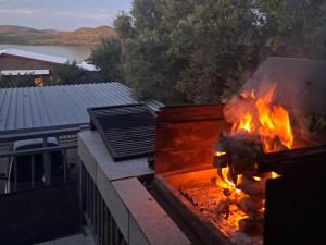 a fire pit on a balcony with flames at OppiDam Gastehuis in Vanderkloof