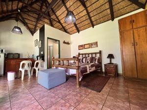 a room with a kitchen with a bed and a table at De Rust Private Nature Reserve in Odendaalsrus