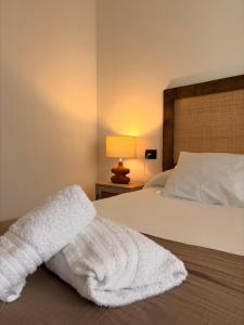 a white towel laying on a bed in a bedroom at Itxinako Balkoia in Murueta-Orozko +10 photos